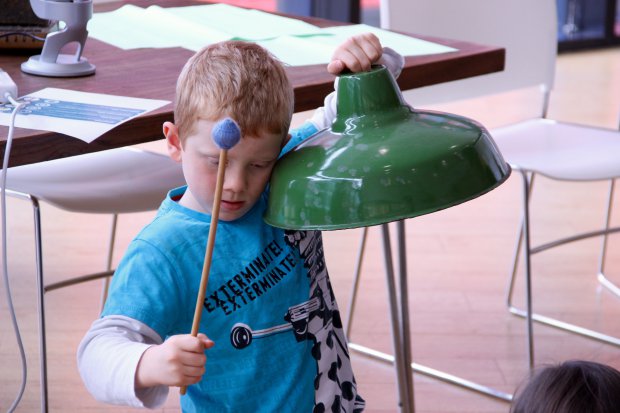 Young boy holding percussion instrument