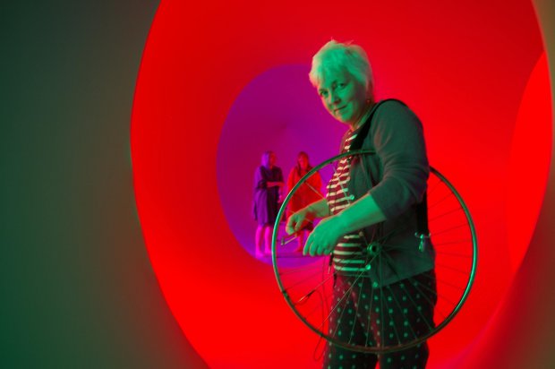 Sylvia Hallet playing a bicycle wheel